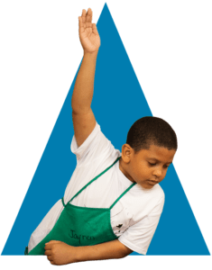 A Boy Raises His Hand In Front of a Blue Triangle